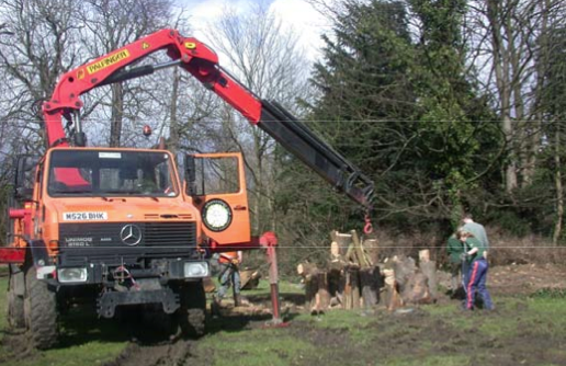 Unimog crane lifting heavy logs